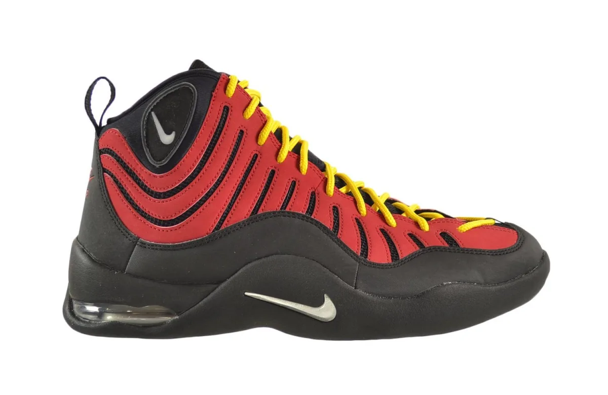  A retro basketball shoe with a chunky black and silver design, featuring the Nike logo on the tongue and the side.