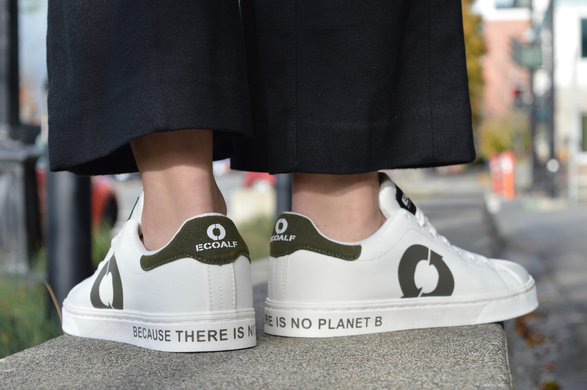 An eco-friendly sneaker made with sustainable materials and colors of white, beige, and light blue. The sole is made from recycled rubber and cork that say's because there is no planet B.