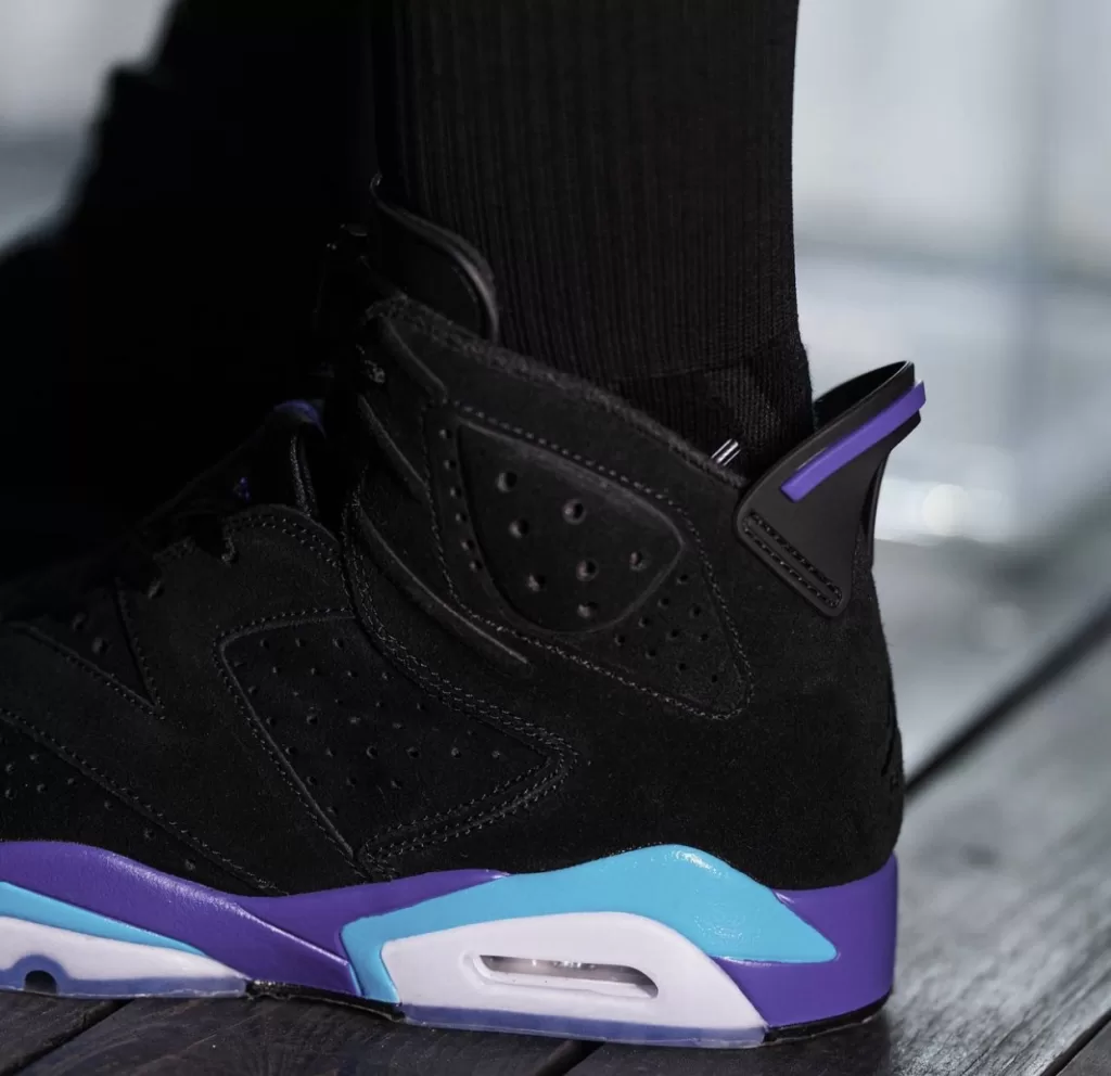 Unveiling the Air Jordan 6 "Aqua" Ahead of Release 4 Image displaying the Air Jordan 6 "Aqua" sneakers in a Black, Bright Concord, and Aquatone color scheme, featuring a sleek design with a Black nubuck upper and contrasting accents, resting on an icy translucent outsole.