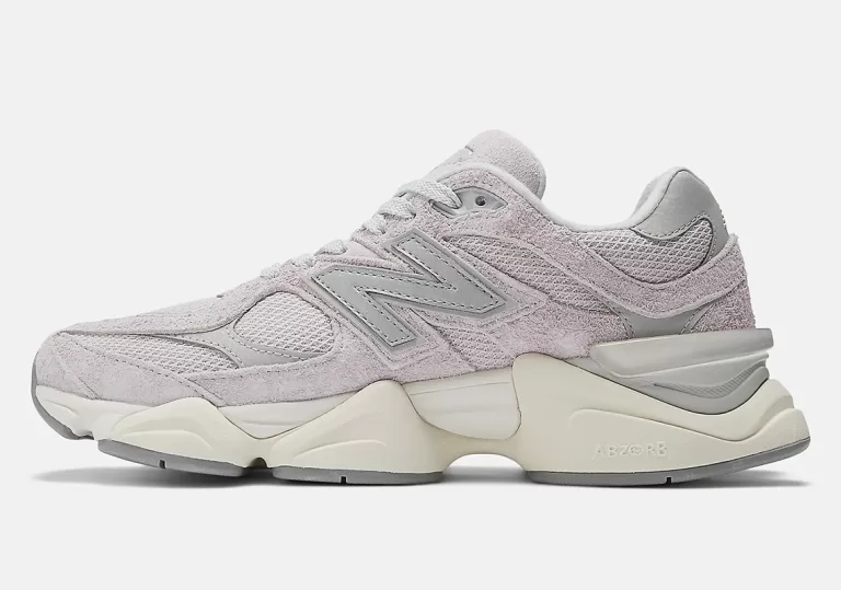 Image showcasing the New Balance 9060 sneakers in the "December Sky" colorway. Muted pink and gray hues with off-white and concrete accents, featuring a shaggy suede overlay and a distinctive diamond-shaped outsole pattern.