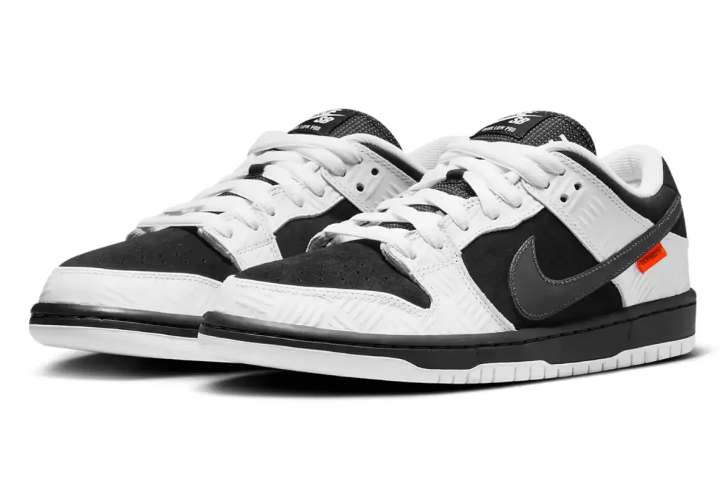 Image of TIGHTBOOTH x Nike SB Dunk Low 'Black' sneakers: A black suede and white leather shoe with orange TIGHTBOOTH branding on the Swoosh and insoles.