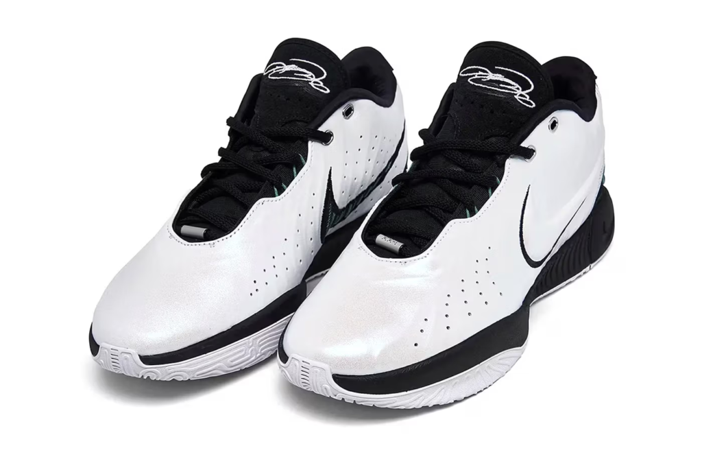 The Nike LeBron 21 Conchiolin is a white, black, and bicoastal masterpiece that honors the Lakers' 21st season in the NBA. The shoe features a pearlescent finish, black accents, and a bicoastal tone that pops on the medial Swoosh, eyestay, and heels. It sits atop a black midsole and white rubber outsole.