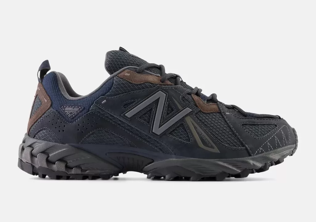 New Balance 610T "Phantom/Blacktop" sneaker with a breathable mesh base and suede and fabric overlays in a black and navy colorway. Brown accents on the tongue and spine. Grey "N" logos. Blacktop midsole and outsole.