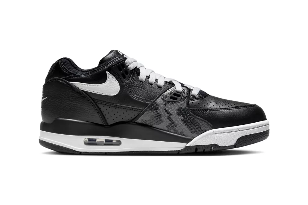 A timeless combination of black and white, this colorway exudes a sophisticated yet understated vibe. The black leather upper is complemented by white Swooshes, tongue, and heel tab, while the snakeskin overlays provide a subtle hint of texture. The Air Jordan 4-inspired sole completes the look with a touch of retro flair.