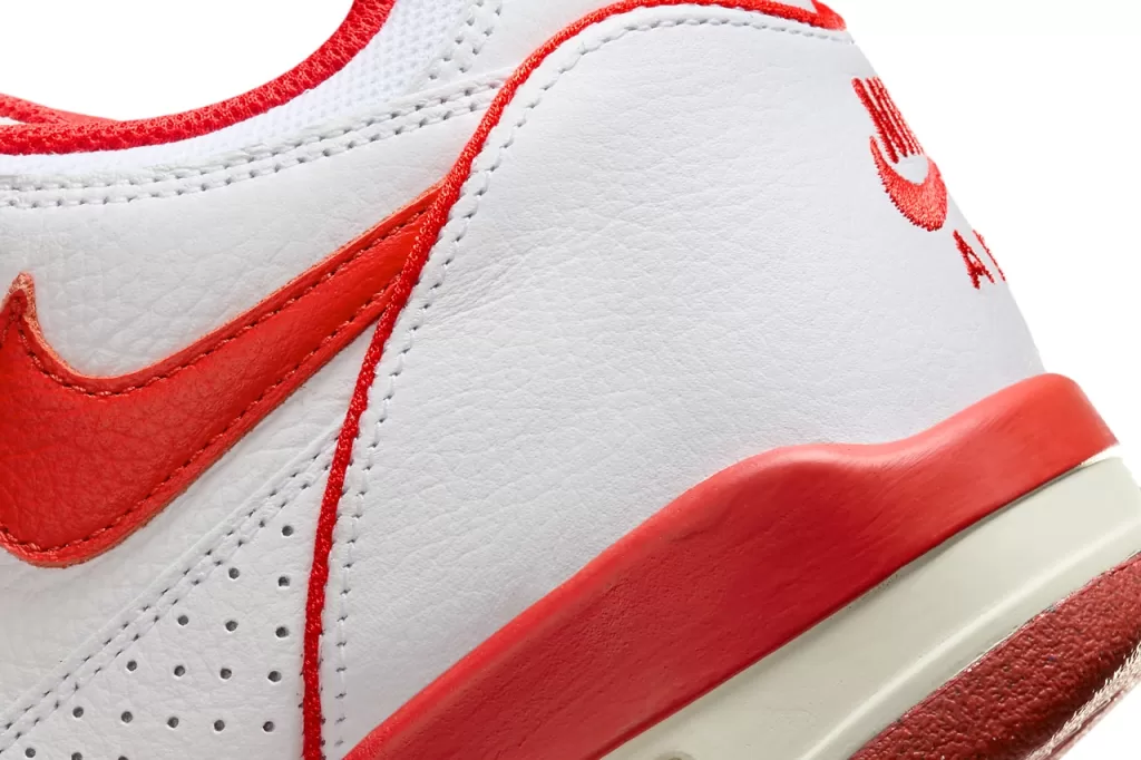 Stussy x Nike Air Flight 89 "White/Habanero Red" - A vibrant take on the classic Air Flight 89, this colorway features a crisp white leather upper with striking habanero red accents on the Swoosh, tongue, and heel tab. The snakeskin overlays on the sides add a touch of luxury, while the Air Jordan 4-inspired sole provides both cushioning and style.